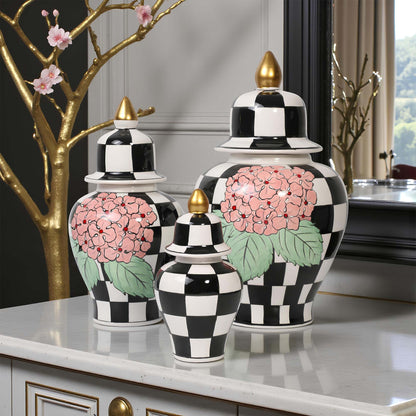 Decorative jars with black and white checkered pattern and pink floral design on a marble surface.