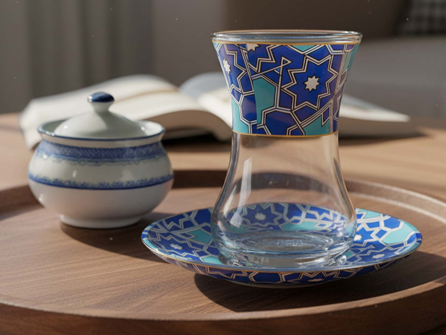 Decorative glass with blue geometric pattern on a wooden table