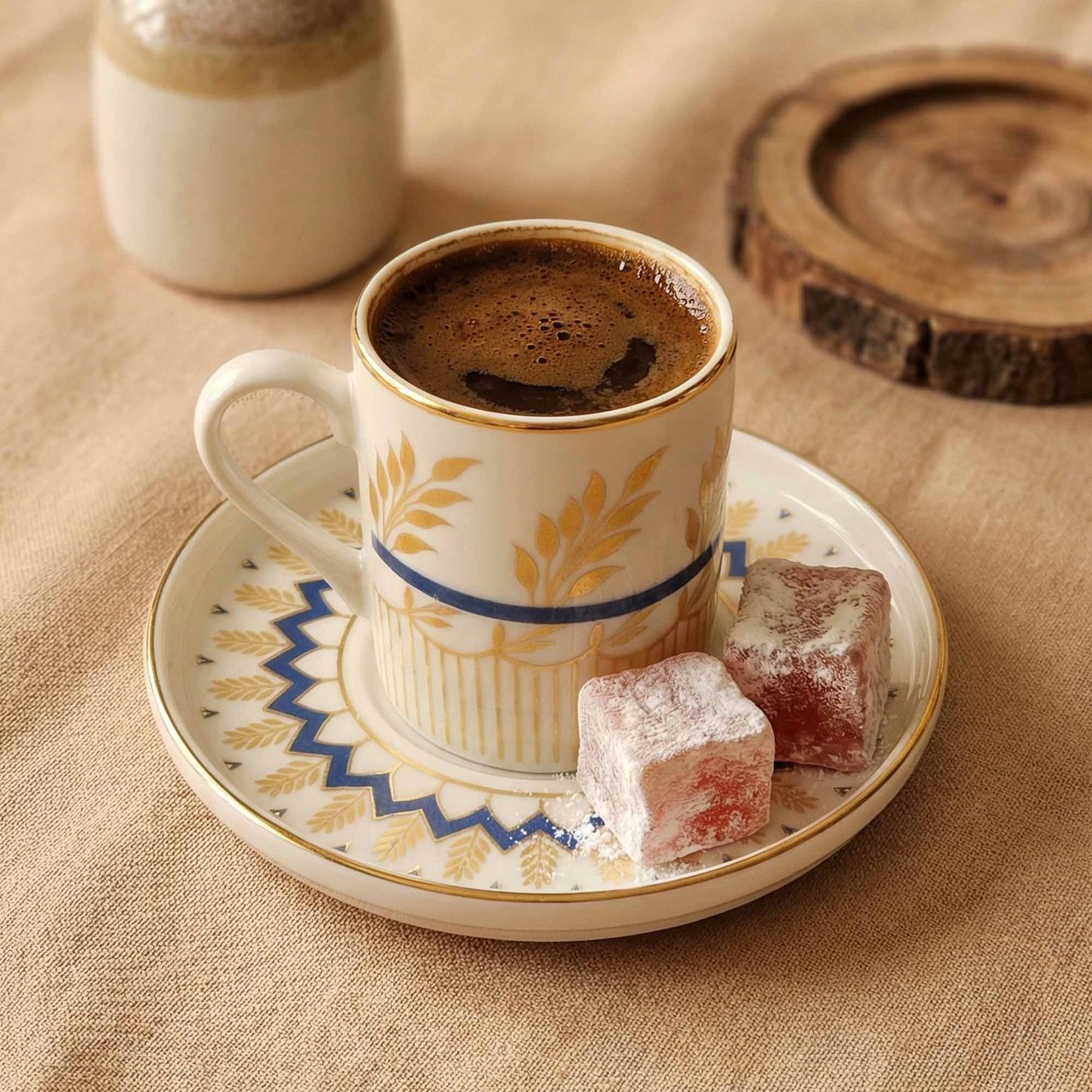 Cup of coffee with a saucer and Turkish delight on a textured surface