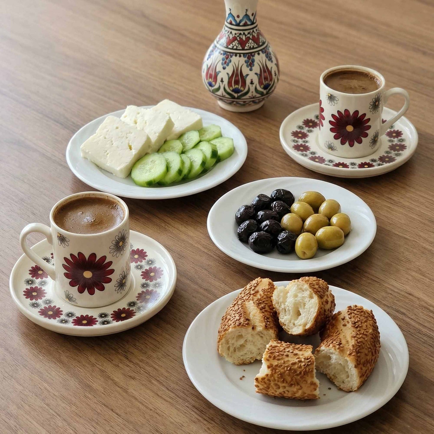 Café con leche with bread, olives, and cheese on a wooden table