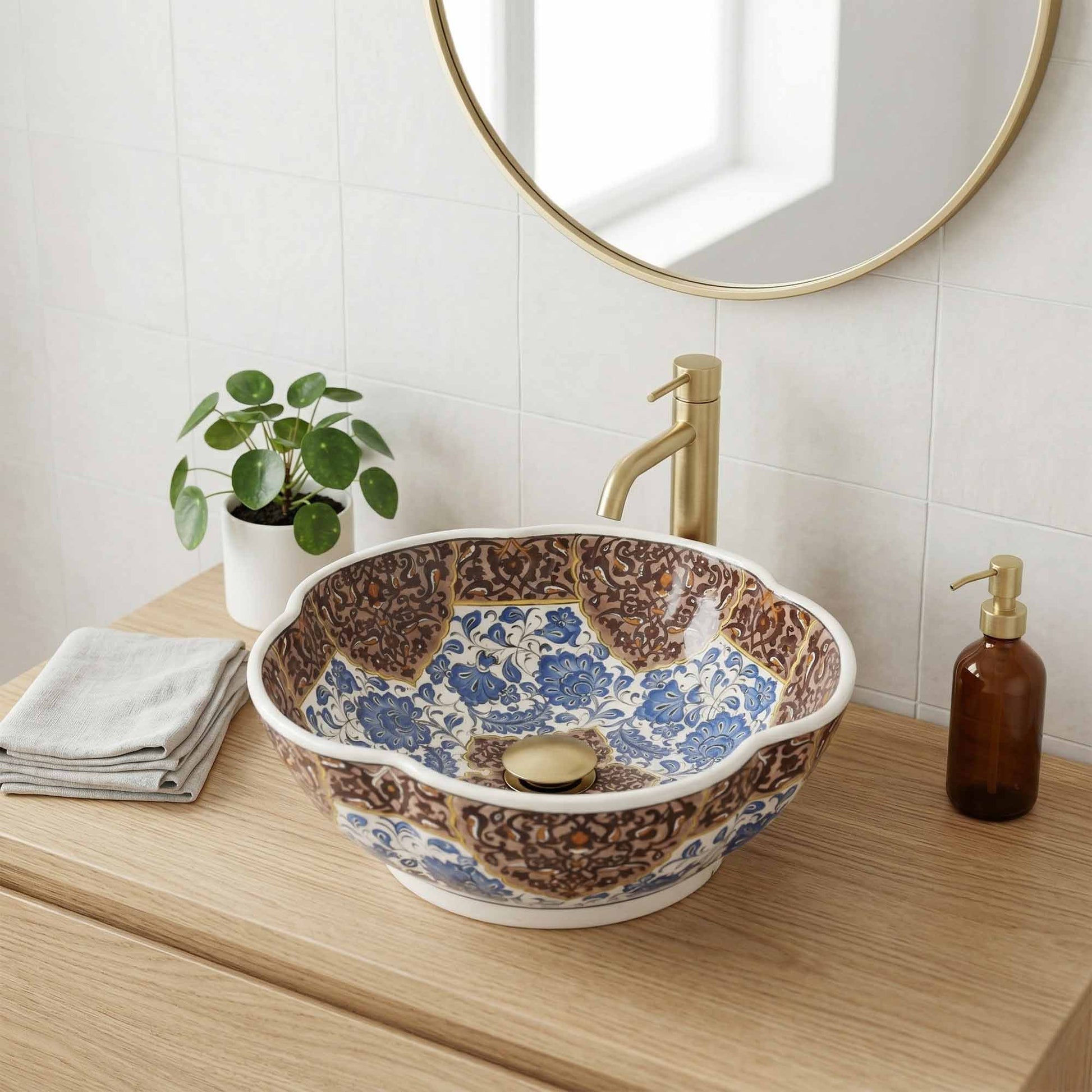 Bathroom vanity with a decorative ceramic sink, gold faucet, and round mirror.