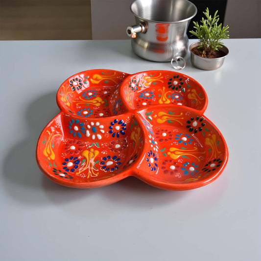 Decorative orange plate with floral patterns on a gray surface