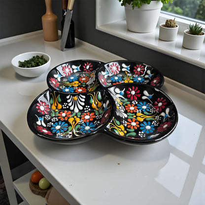 Colorful ceramic plate on a kitchen counter with a window in the background.