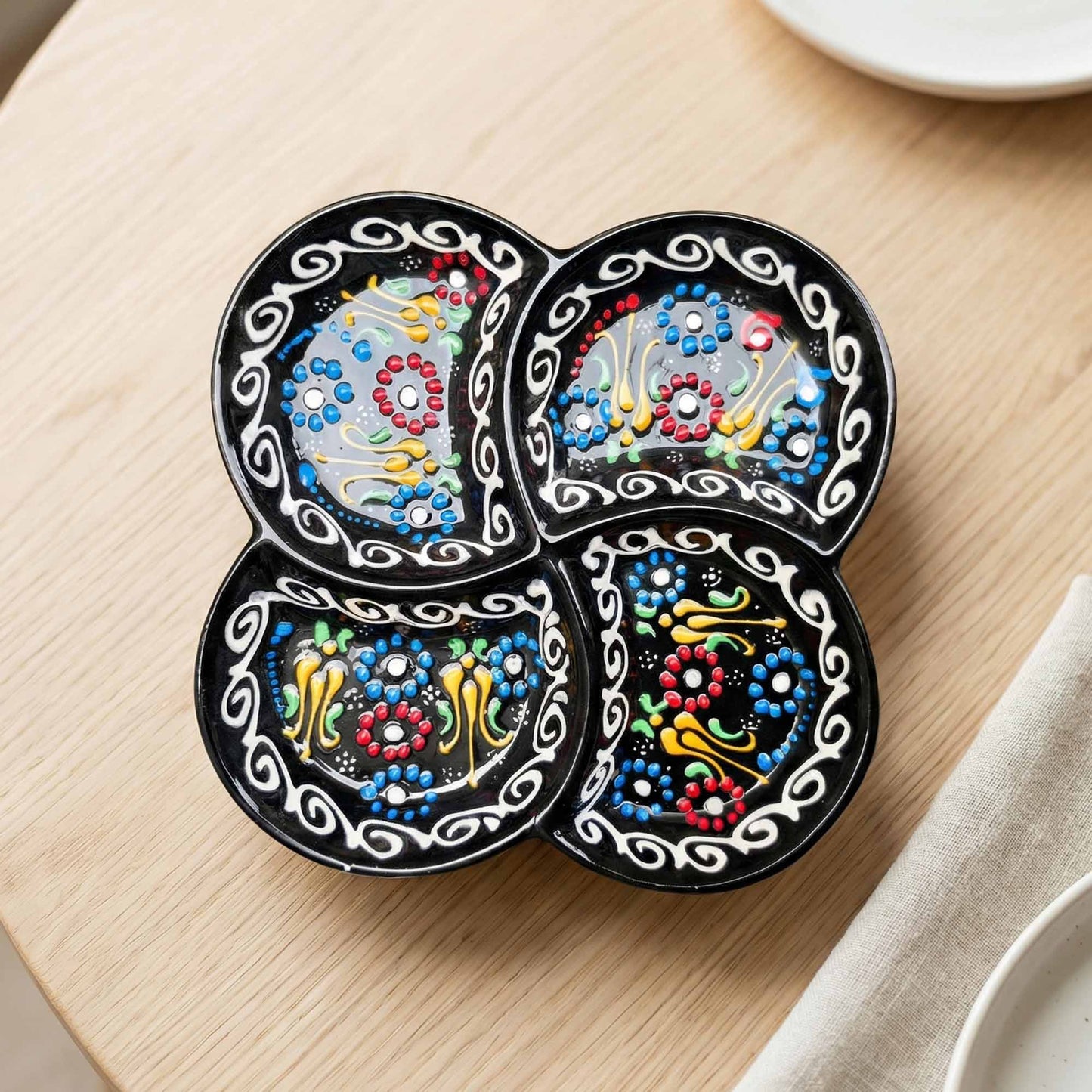 Decorative snack platter with colorful patterns on a wooden surface.