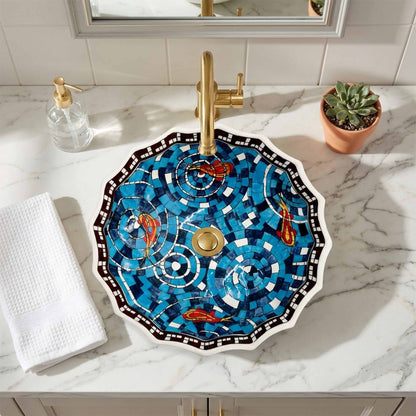 Decorative ceramic sink with gold fixtures on a marble countertop