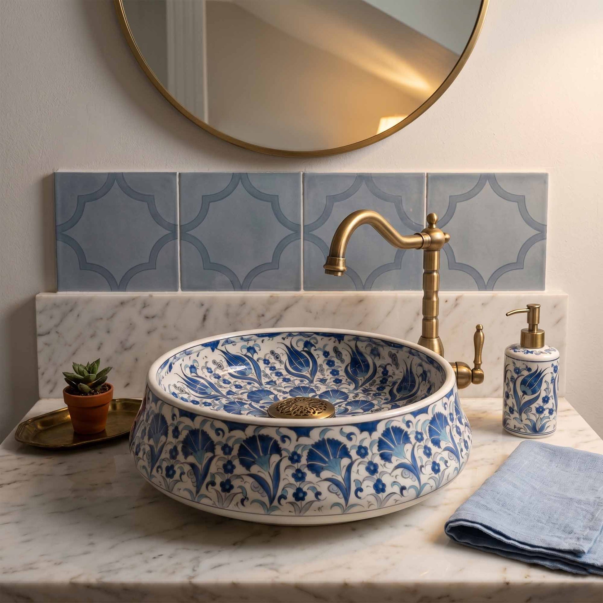 Bathroom with a decorative blue and white sink, gold faucet, and patterned tiles.