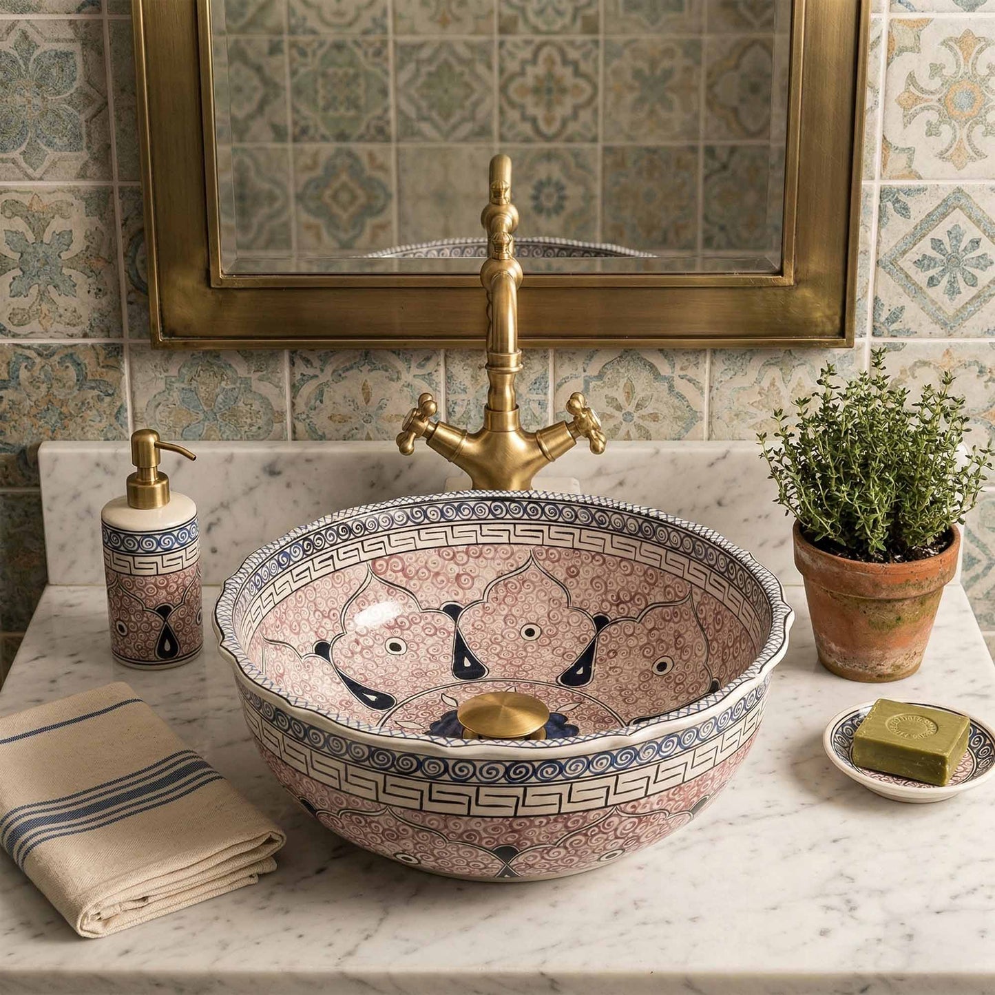 Decorative ceramic sink with gold faucet in a bathroom setting