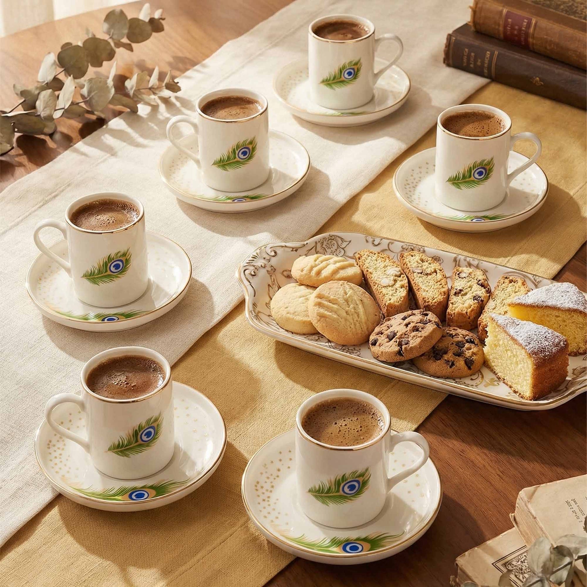 Coffees with saucers on a table with pastries