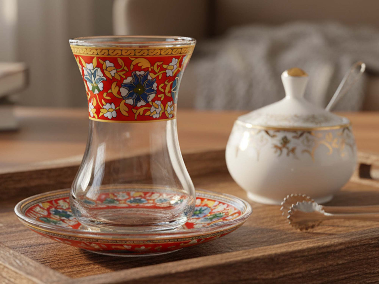 Decorative glass teacup with floral patterns on a wooden table